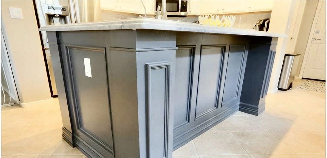 Finished gray paneled kitchen island with new countertop
