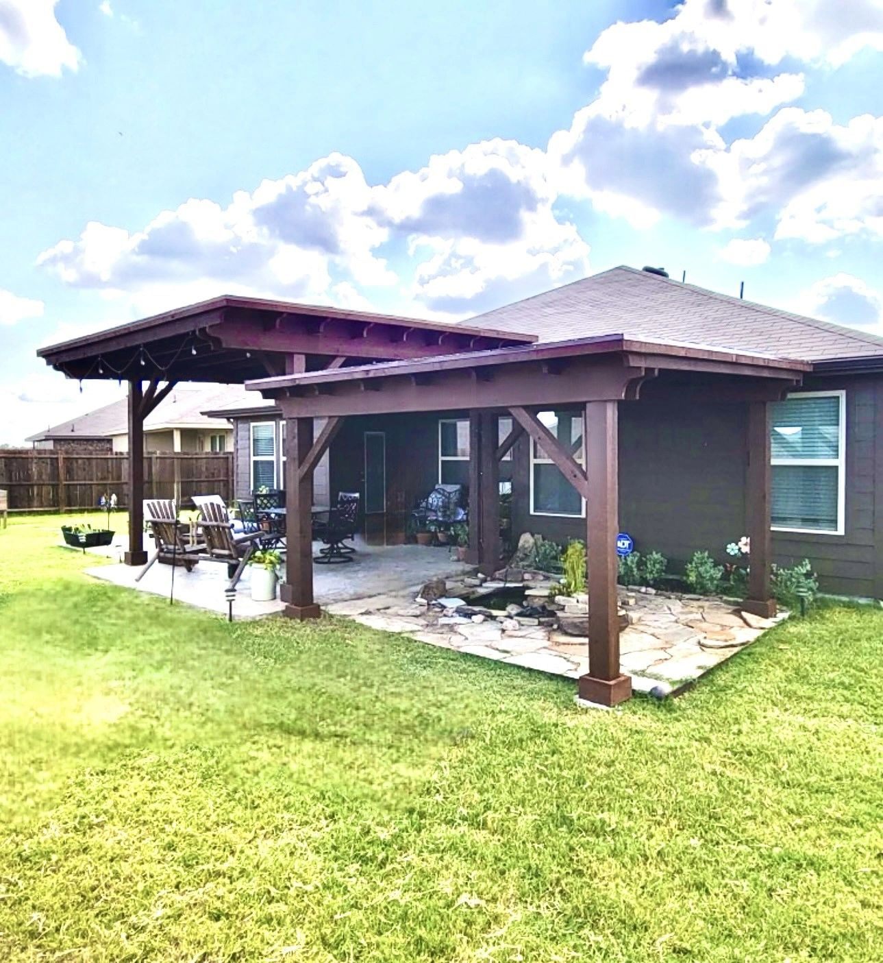 Cedar patio cover with stone pond and landscaping