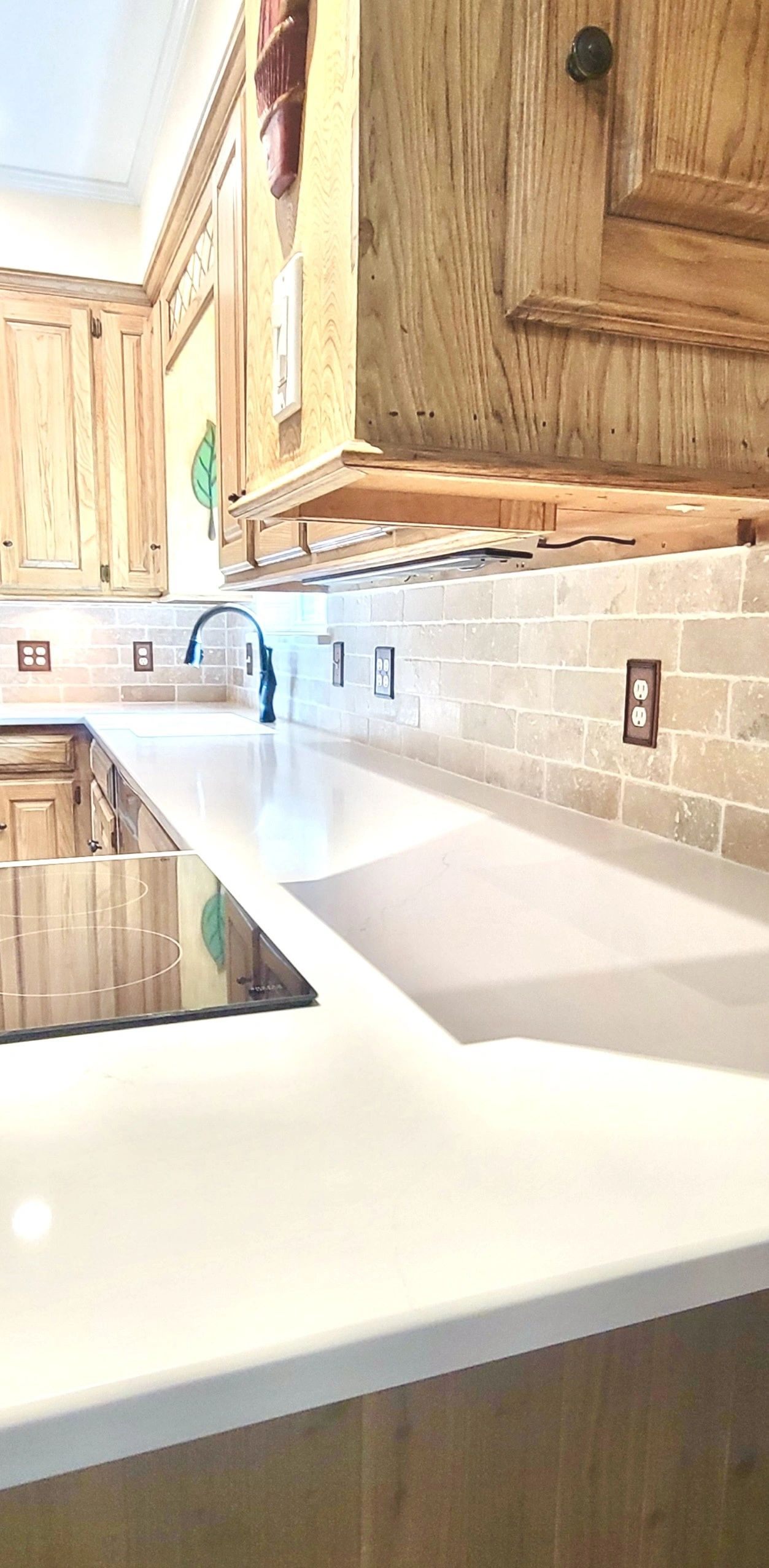 Remodeled oak kitchen with travertine backsplash