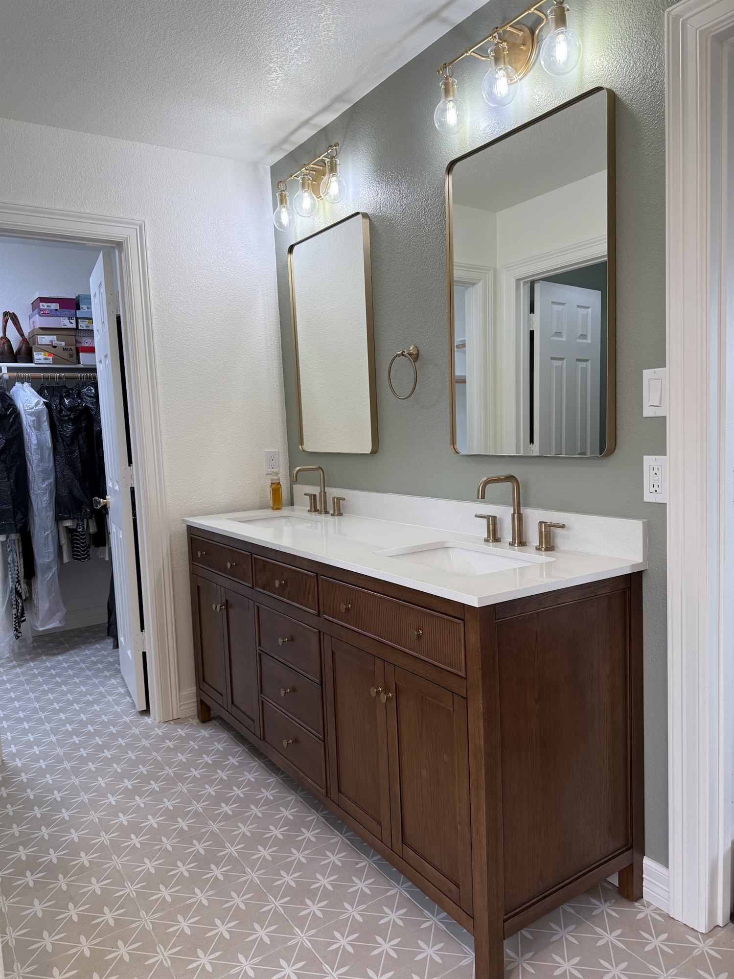 Master bathroom remodel with walnut double vanity and brass fixtures