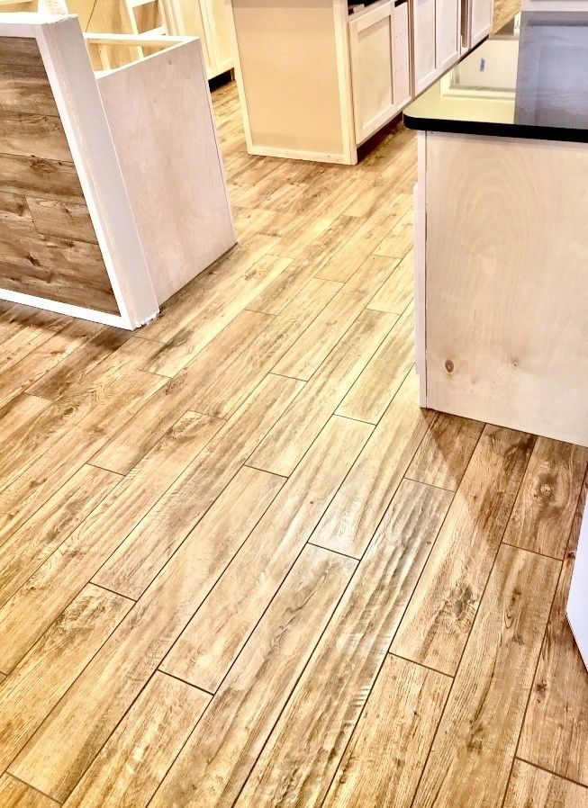 Wood-look plank tile flooring being installed